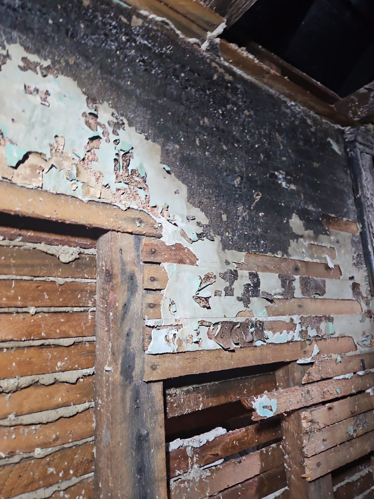 Burned wall framing and exposed lath.