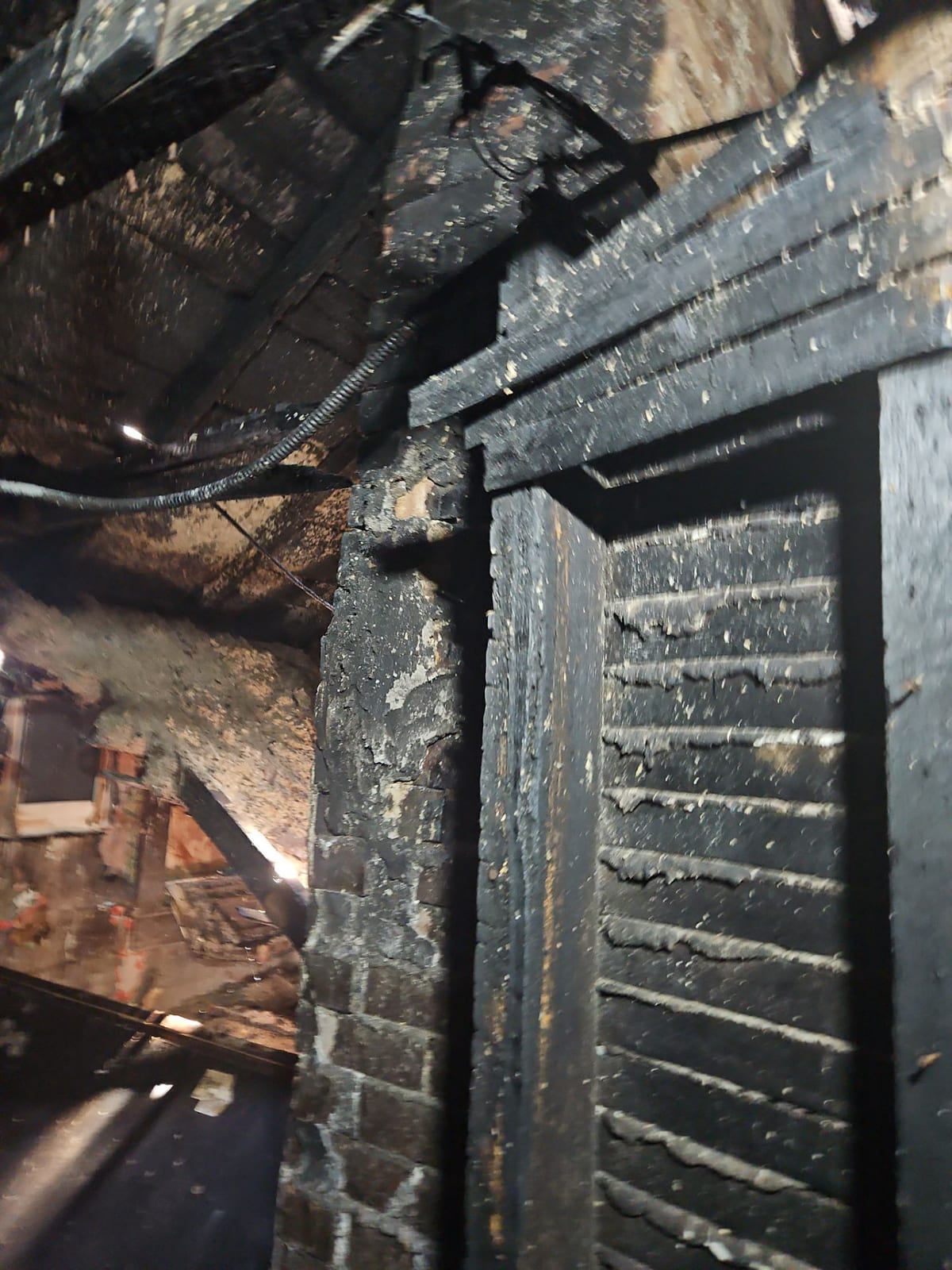 Fire and smoke spread through interior walls and doorways.