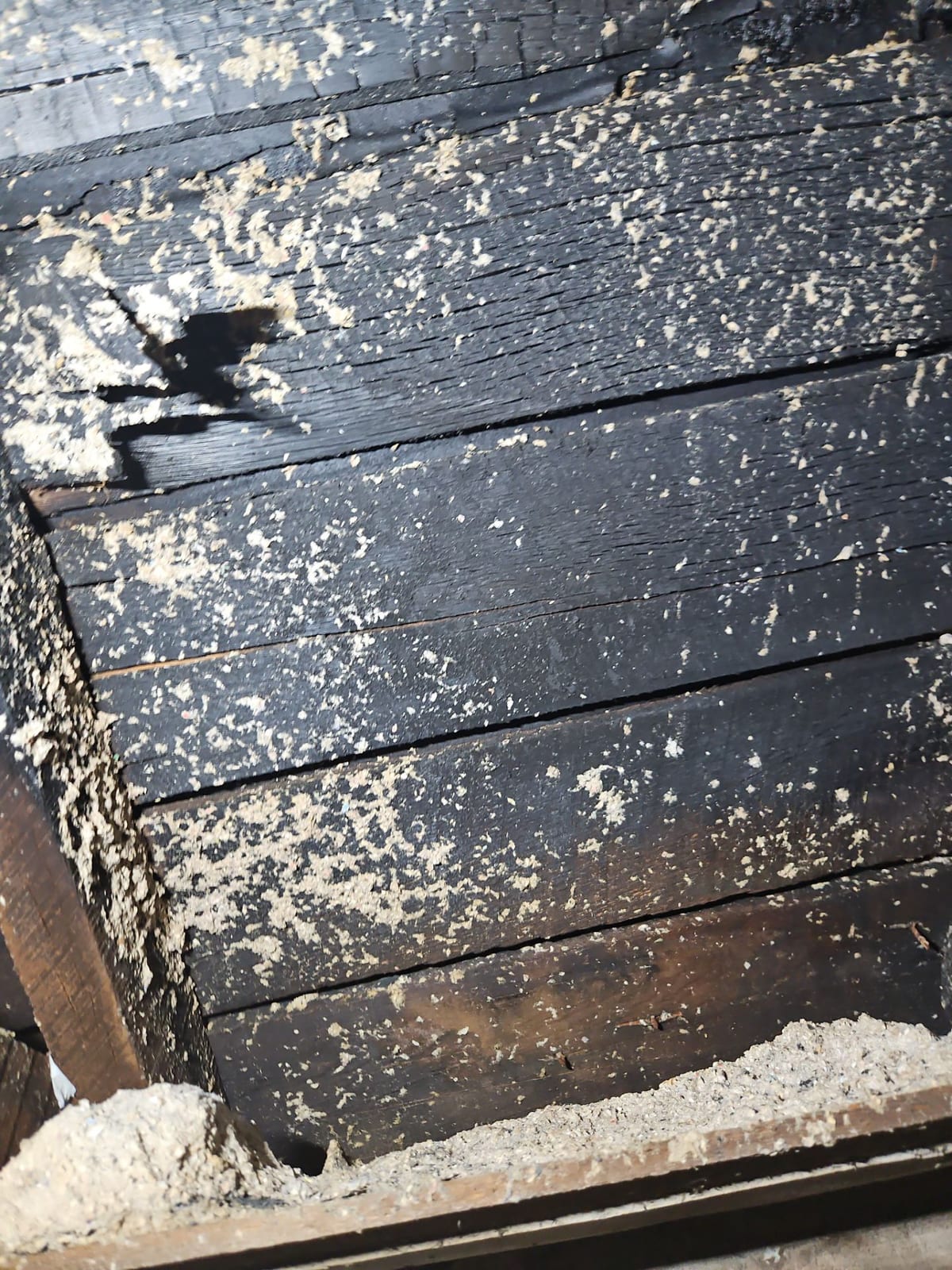 Deep charring in the home's structural framing — fire this intense compromises load-bearing members.