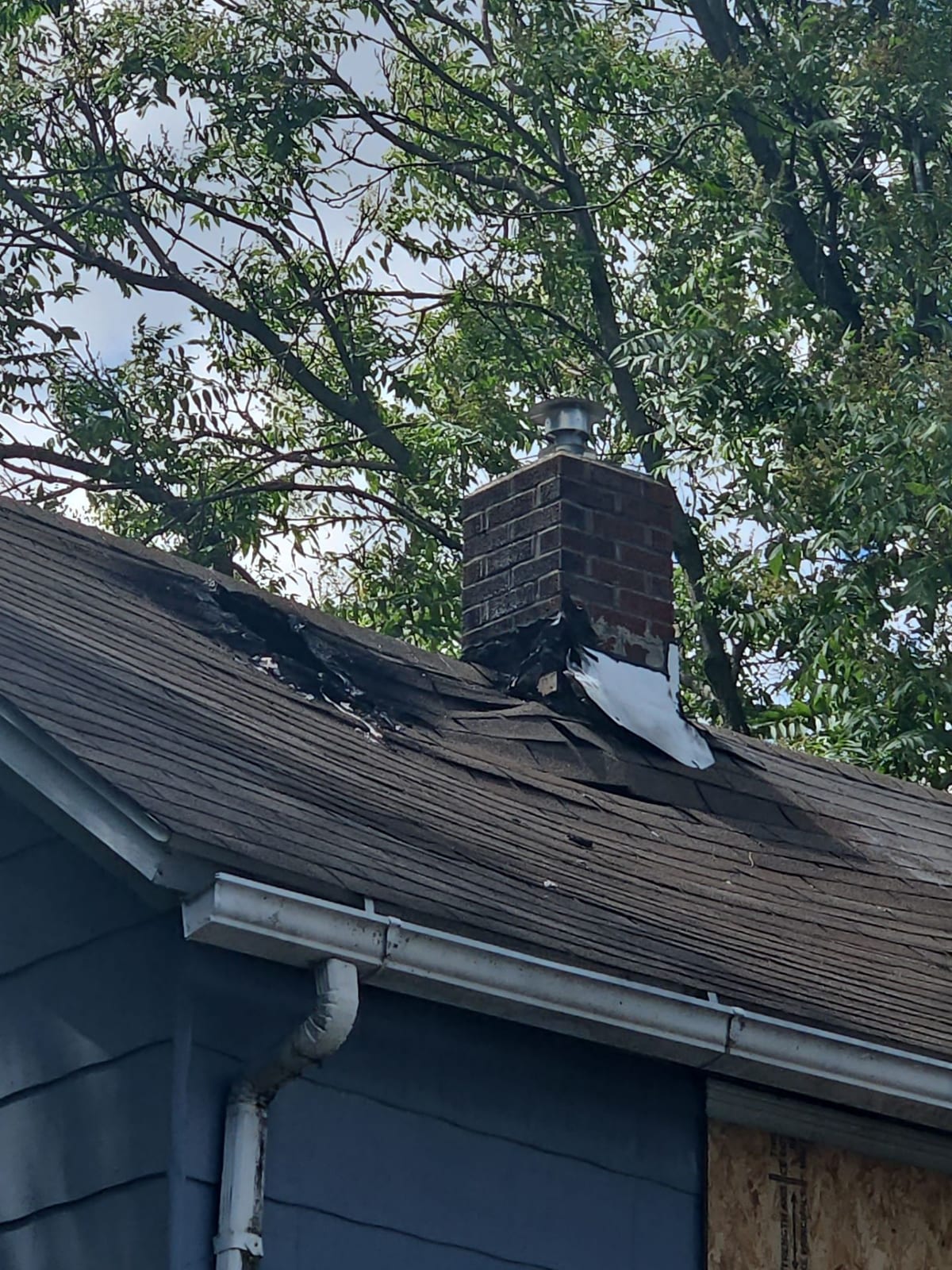 Fire-damaged roof and chimney of a home in Akron, Ohio