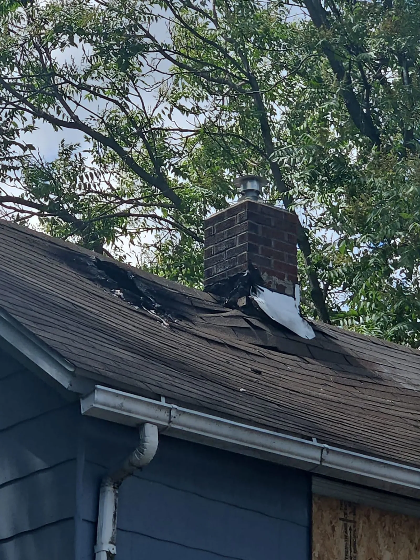 Fire-damaged roof and chimney of a home in Akron, Ohio
