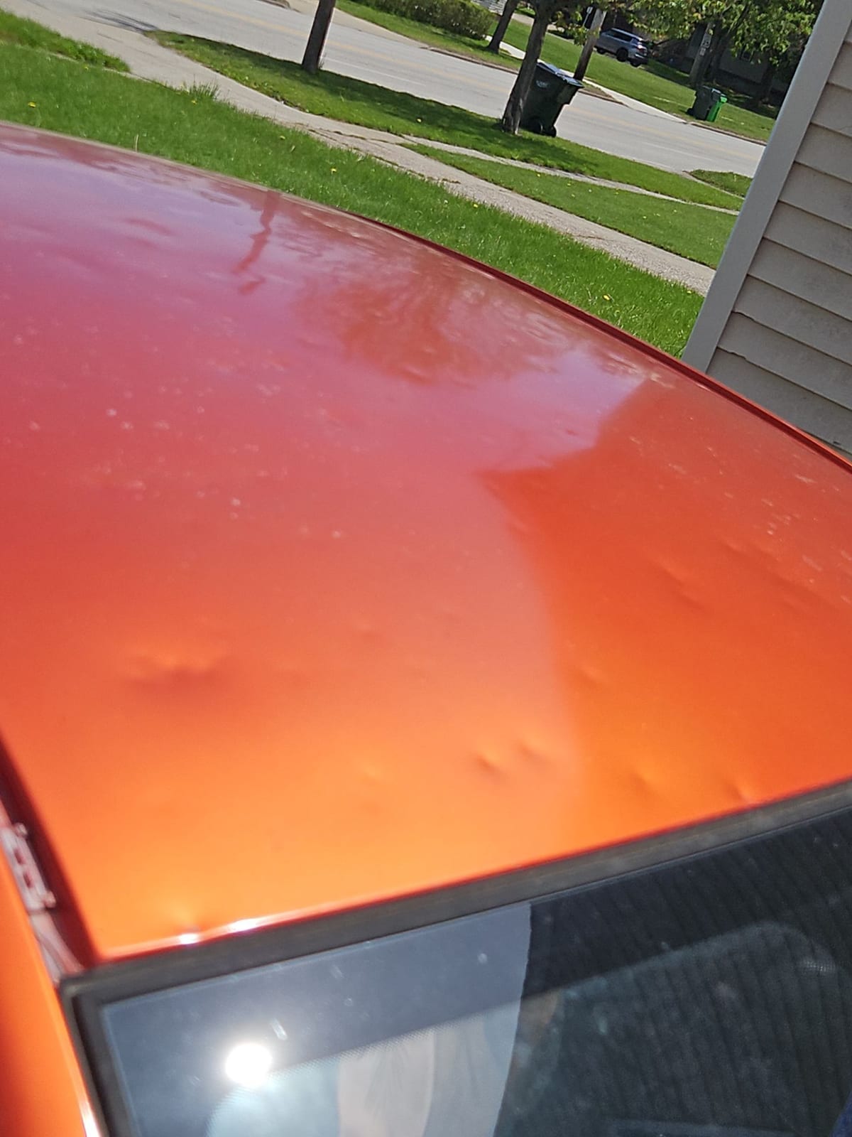 Hail dimples across a vehicle at the property — physical evidence of the same storm that struck the home.