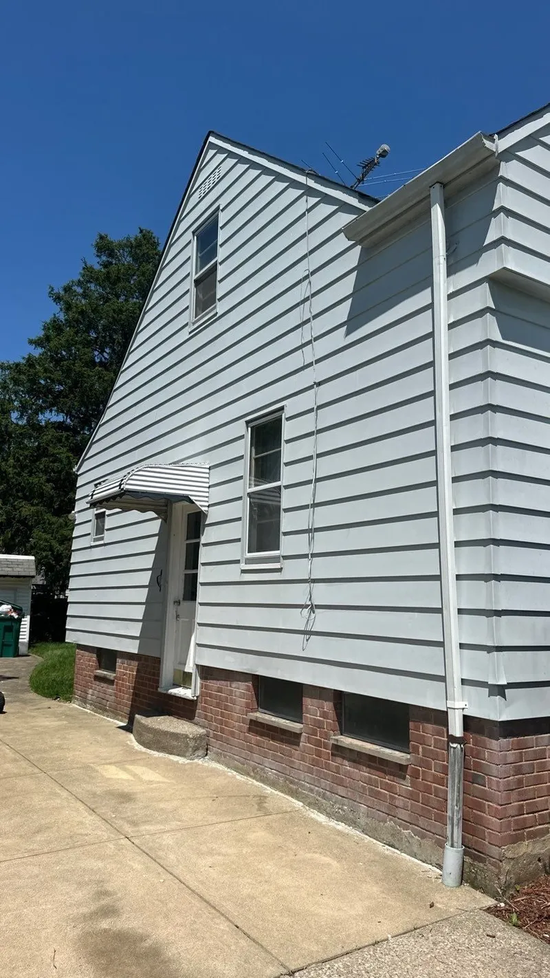 A full side elevation — hail is proven by the pattern across the whole property, not a single dent.