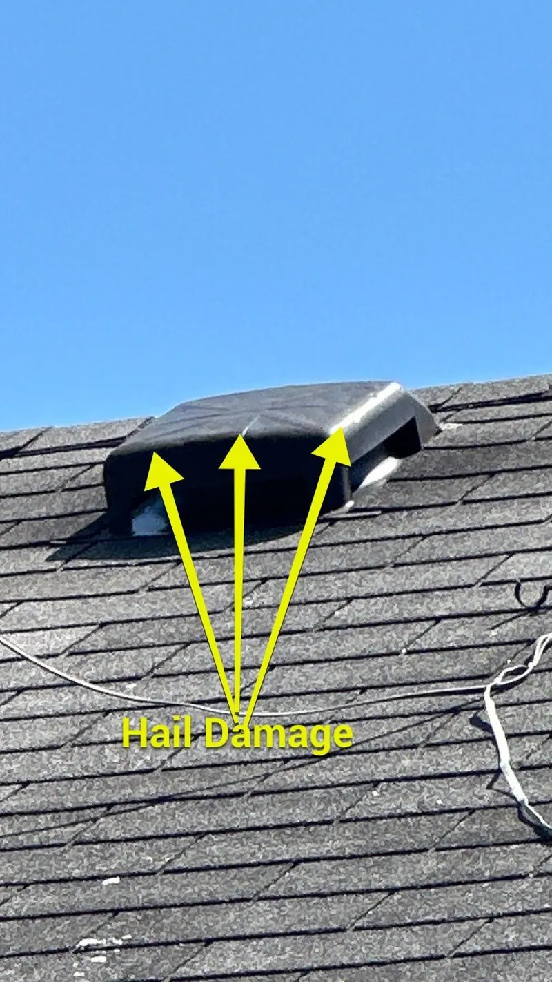 Another roof vent battered by the same storm — hail rarely spares just one spot.