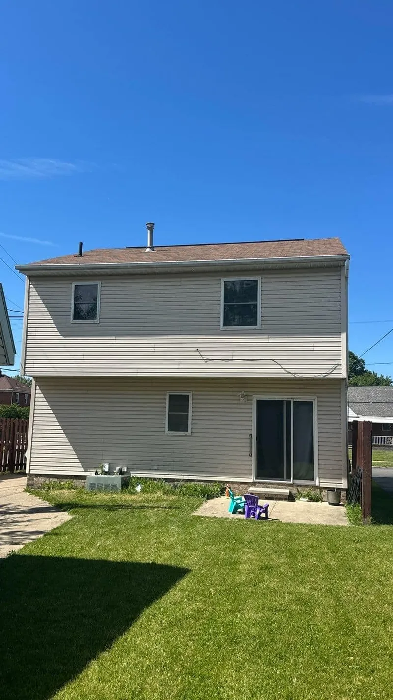The full rear elevation documented — roof damage is proven across the whole home, not one shingle.