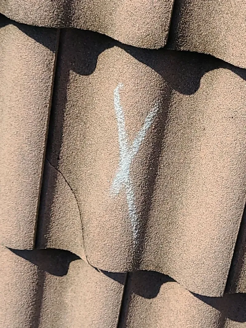 Every damaged tile is chalk-marked and photographed — the record that proves the count.