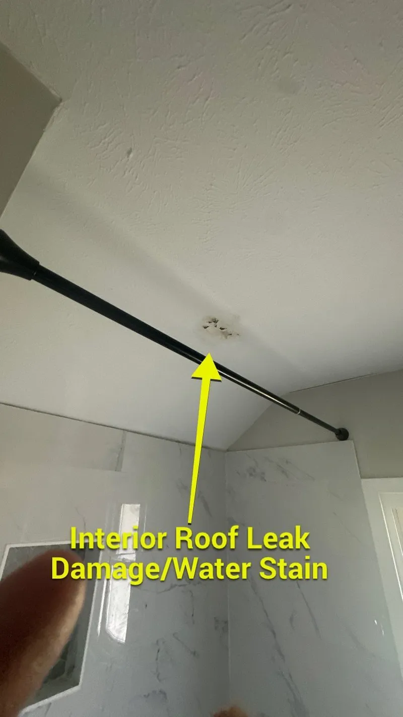 A roof-leak stain on the bathroom ceiling — moisture finding its way to the finished space.