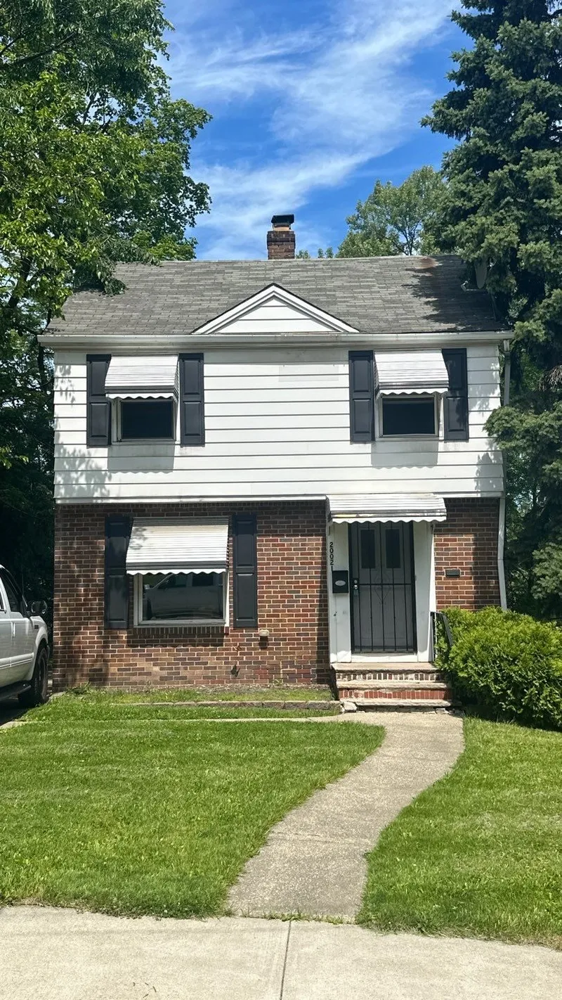 The Euclid home — a pitched-roof colonial where a storm-damaged roof led to water inside.