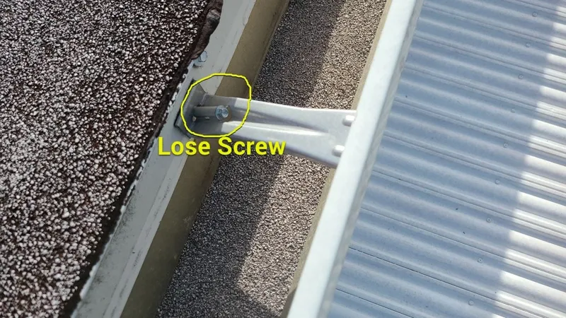 A loose screw at a roof-mounted fixture — another entry point for water.