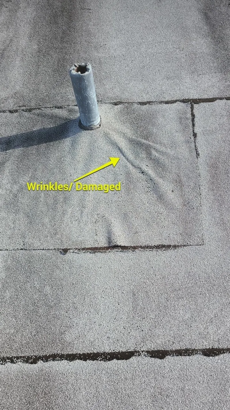 Wrinkled, lifting roof membrane — documented as storm-damaged, not simply “worn out.”