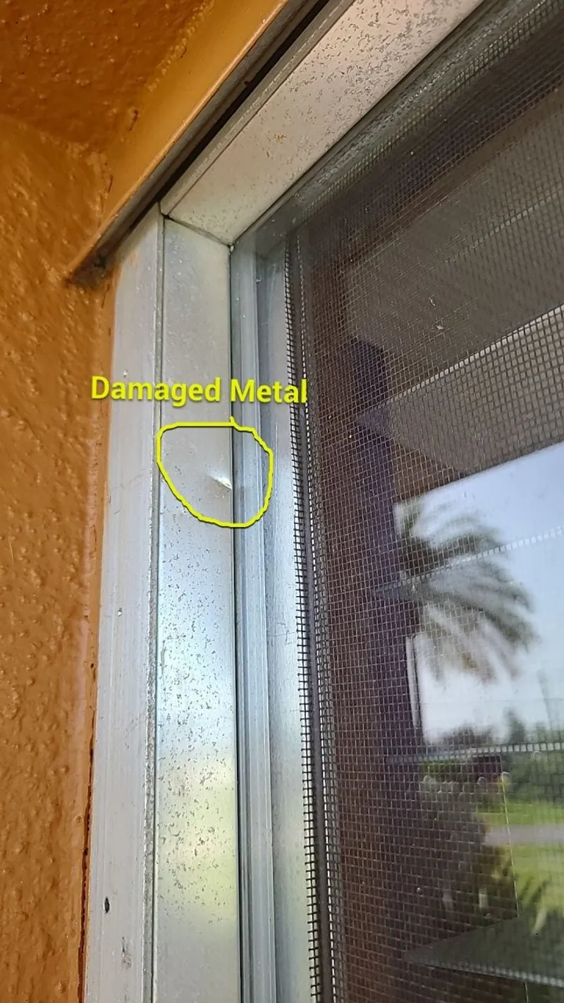 Storm-damaged window metal, documented as part of the same weather event.